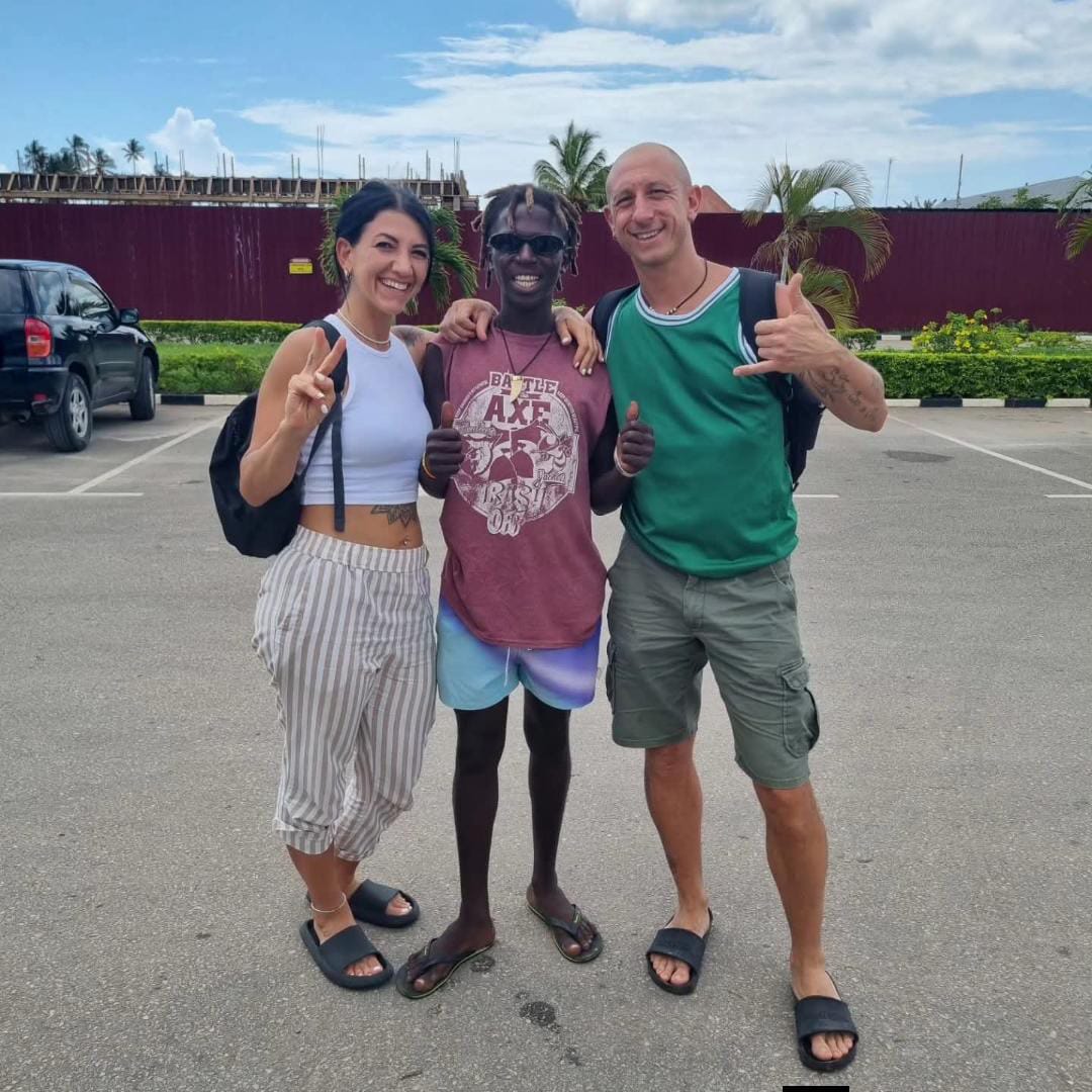 Rama with happy travelers after a Zanzibar tour